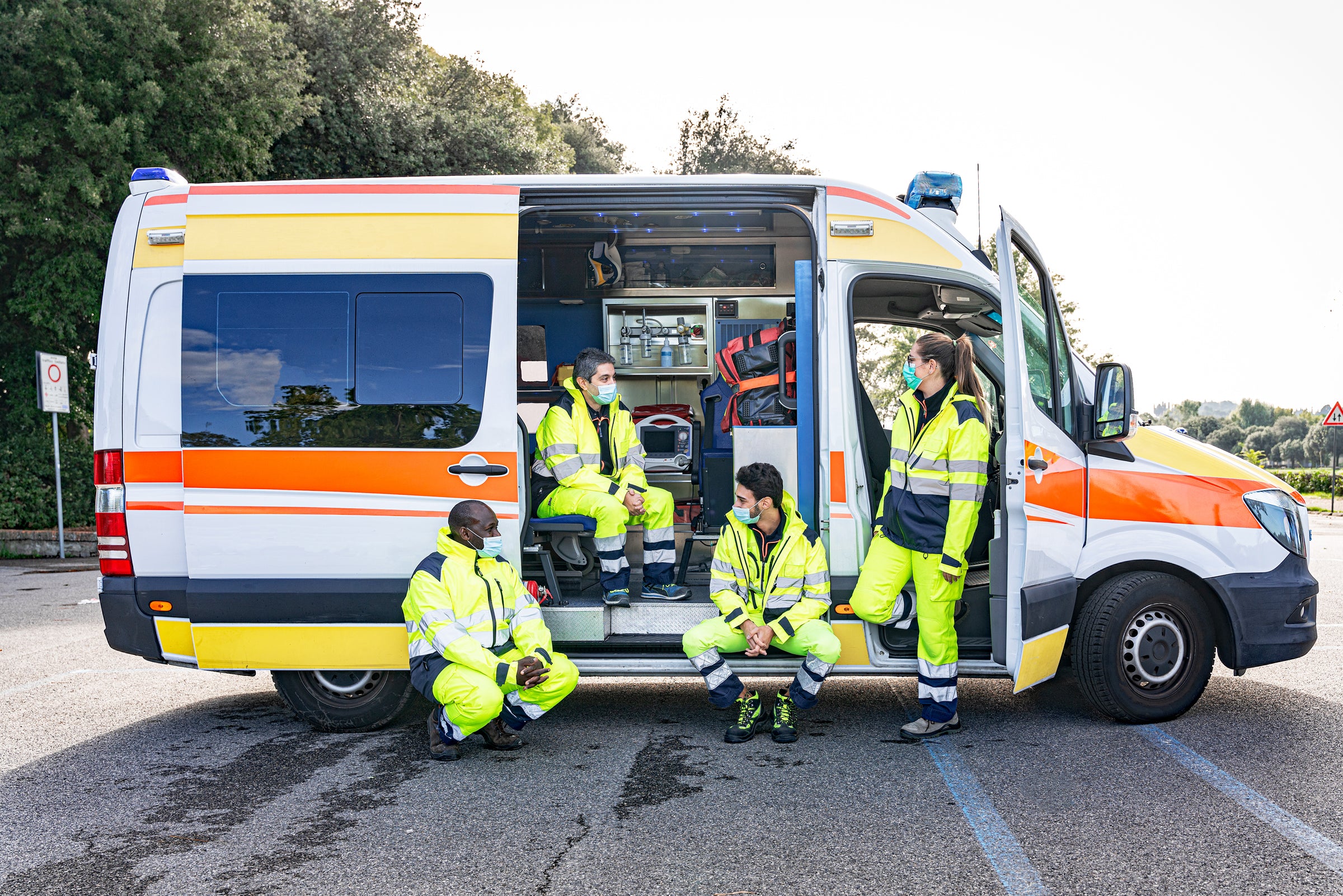 Paramedics in High Visibility Clothing and Ambulance Image